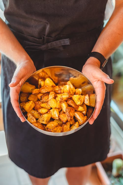 A bowl of toasted potatoes.