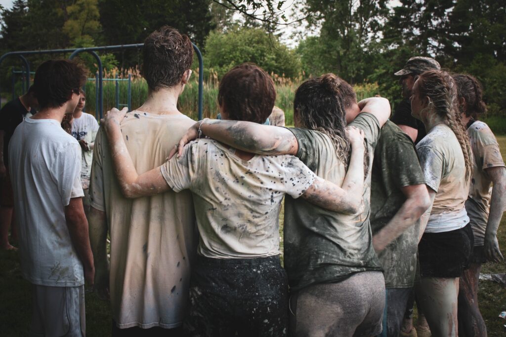Employees gather around after a paintball match in a Team Building activity, a Thanksgiving Gift Idea for employees