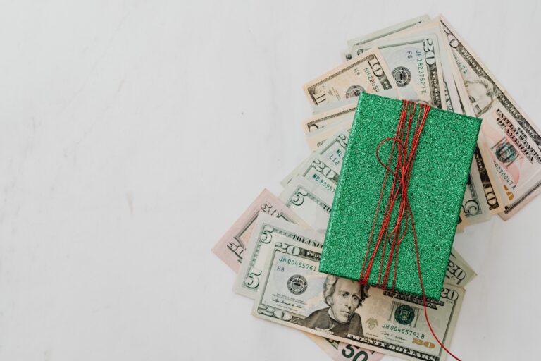 A load of cash under a wrapped gift AS AN Ideas to wrap money gifts for Christmas.