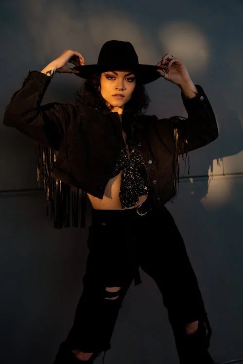 Cowboy Christmas Party ideas for women outfit. Fringe jacket in jeans and cowboy hat