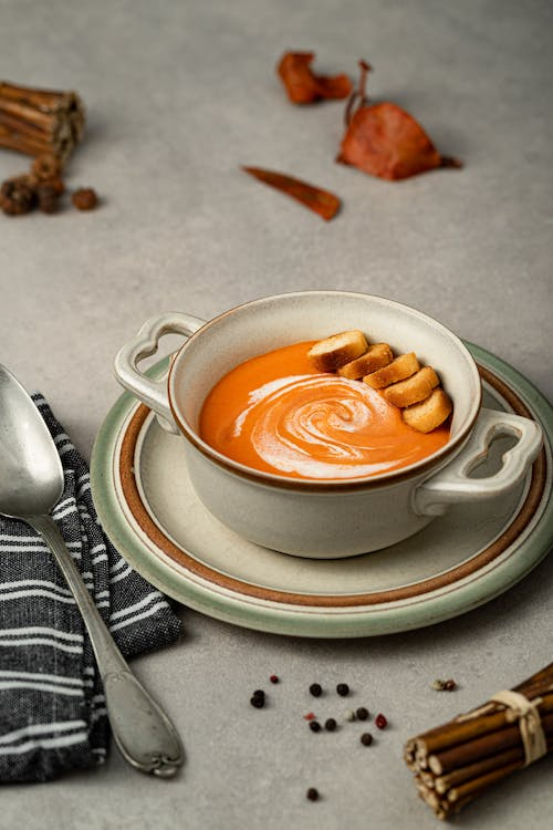 Thanksgiving Butternut Squash Soup Recipe in a ceramic earth toned Thanksgiving soup bowl as a Thanksgiving soup recipes.