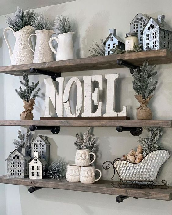  White Christmas shelf decor ideas with white cottages, sleigh and noel sign