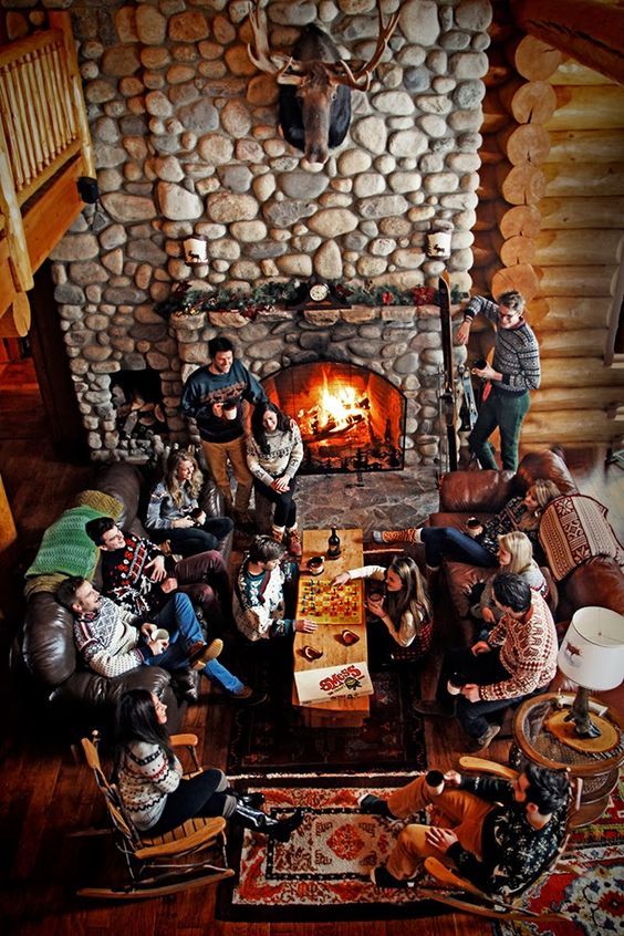 game night around the fire place with friends in ugly sweaters as the indoor winter activities for adults.