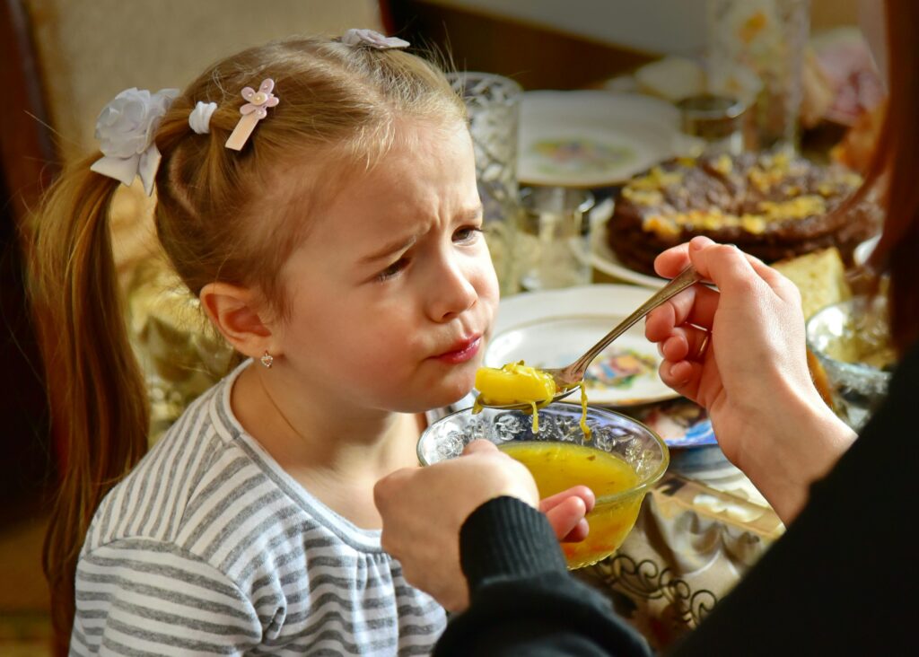 a kid blowing a hot New Year’s Eve Soup