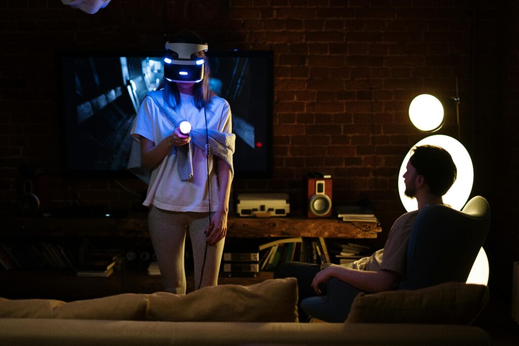 A woman in a HR headset playing games with a man for indoor winter activities for couples