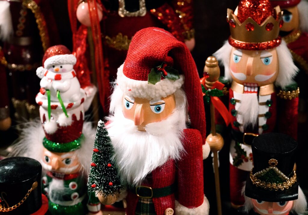 Christmas shelf decor ideas with Santa figurines and Santa nutcracker