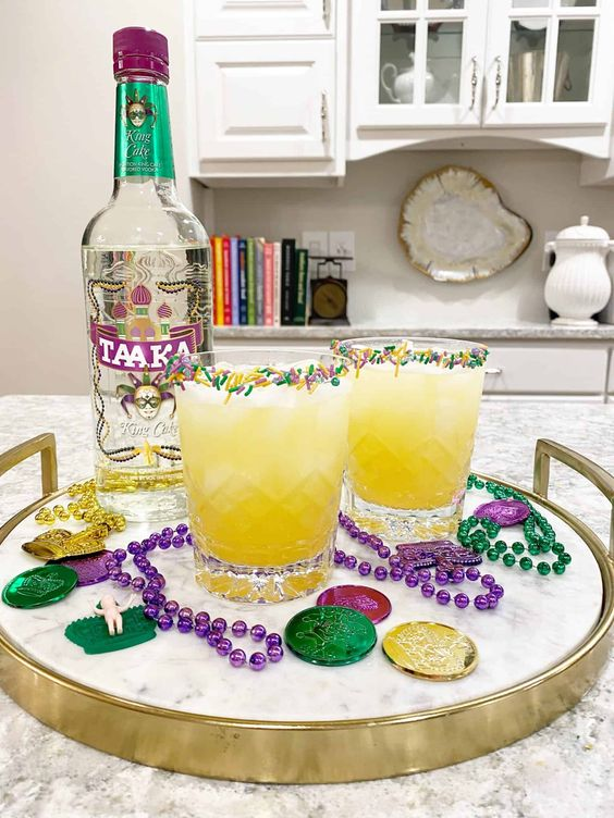 Mardi Gras party ideas for adults cocktail drinks in yellow with mardi gras colored sprinkles