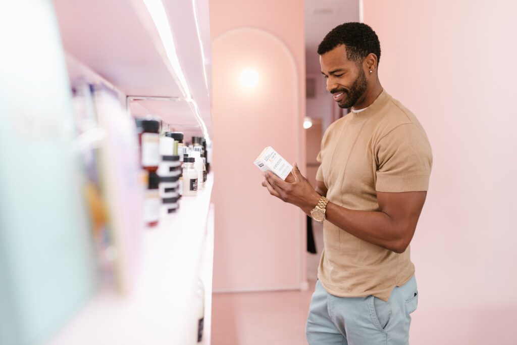 Valentine's Basket Ideas for Him a man picking a skincare product on the shelf