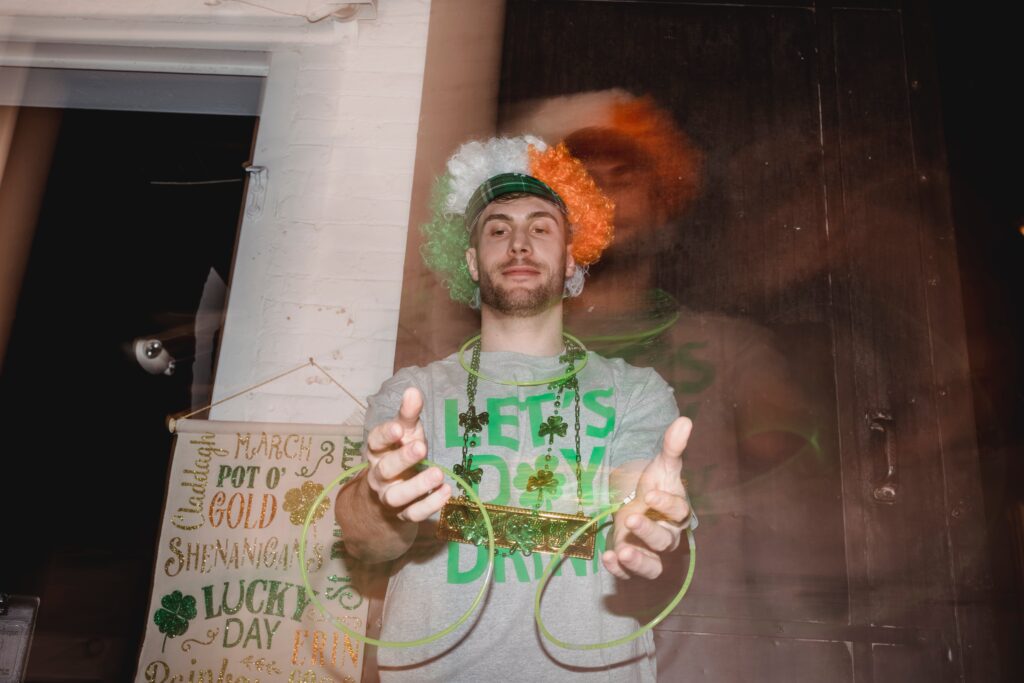 A man playing to green light sticks for St Patrick's Day office ideas